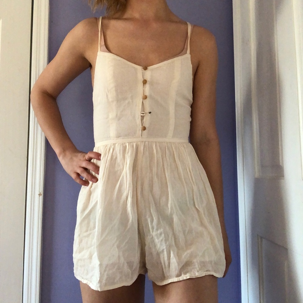 Cream linen romper with wooden buttons